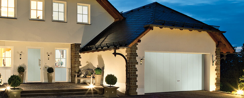 Up-and-over garage door in traffic white with vertical slat motif