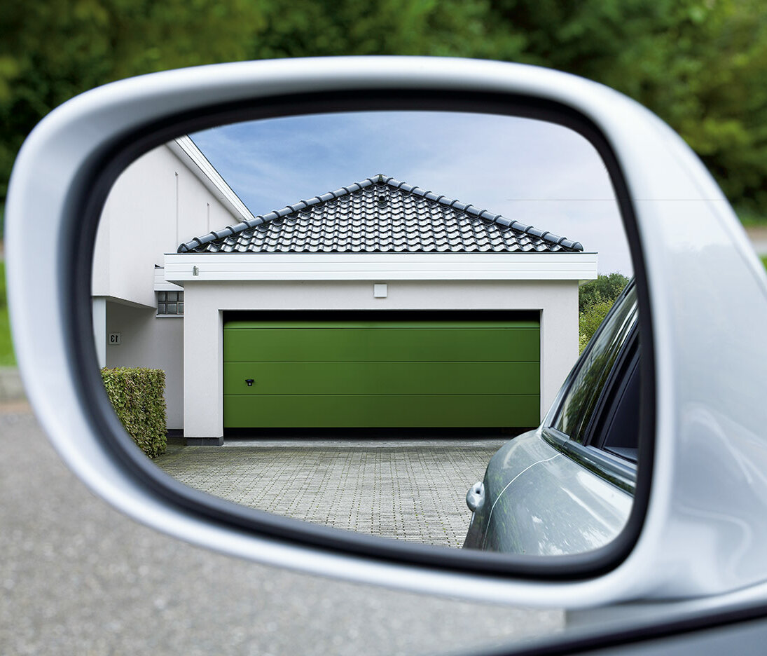 Sectional garage door in moss green
